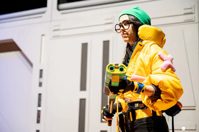 Yellow-Clad Cosplayer with Water Blaster at Vienna ComicCon 2022 Championship