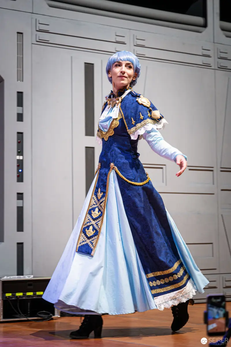Cosplay Central Crown Championship Contestant in Ornate Blue and White Gown