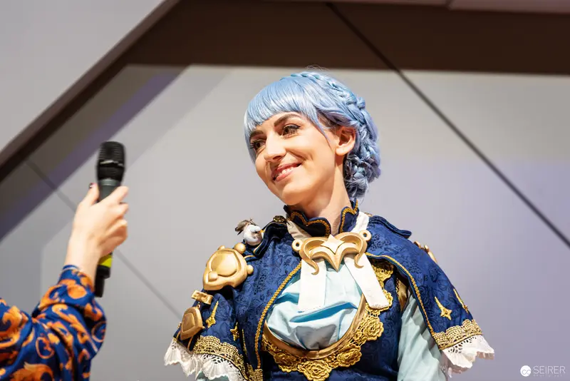 Blue-Haired Cosplayer on Stage at Vienna ComicCon 2022 Costume Championship