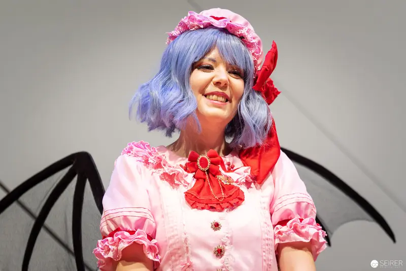Blue-Haired Cosplayer in Pink Ruffles at Vienna ComicCon 2022 Costume Championship