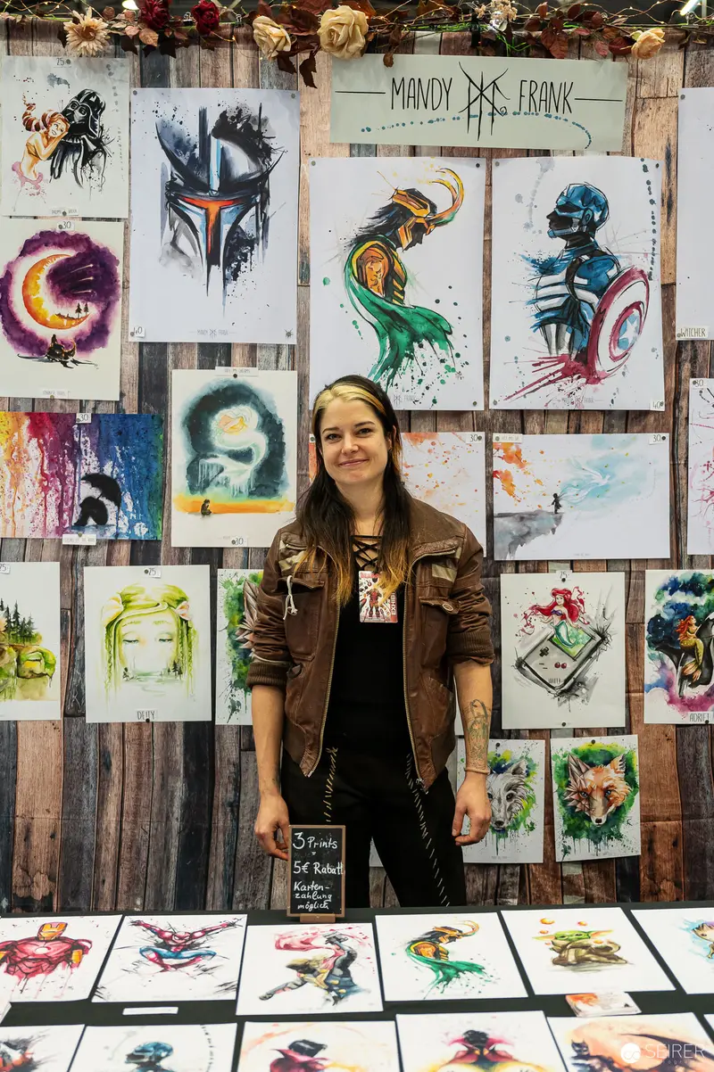 Artist at Vienna ComicCon Displaying Watercolor Superhero Artwork Collection