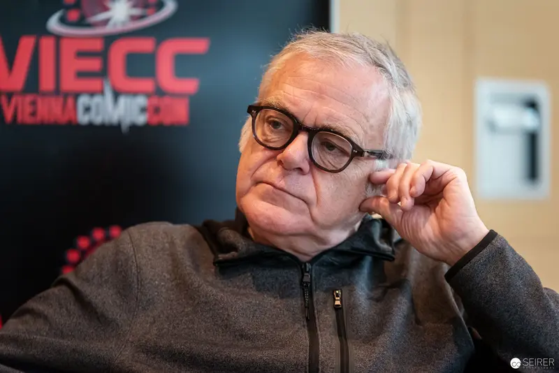 Reflective Speaker at Vienna ComicCon 2022, Contemplative Moment Captured