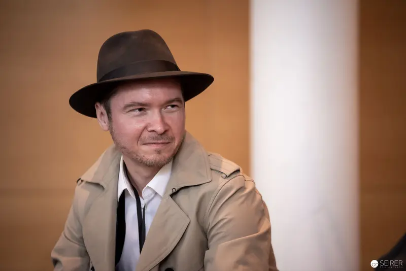 Fedora-Wearing Man in Beige Trench Coat at Vienna ComicCon