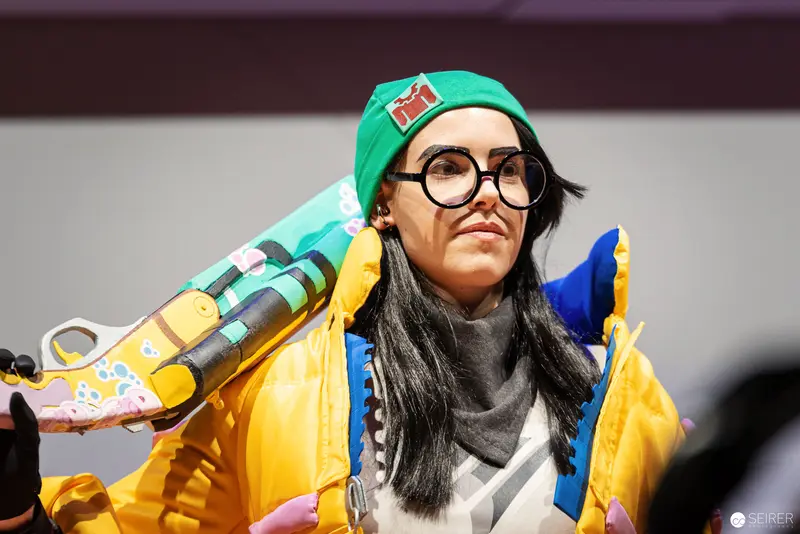 Cosplayer in Green Beanie and Yellow Jacket at Vienna ComicCon 2022