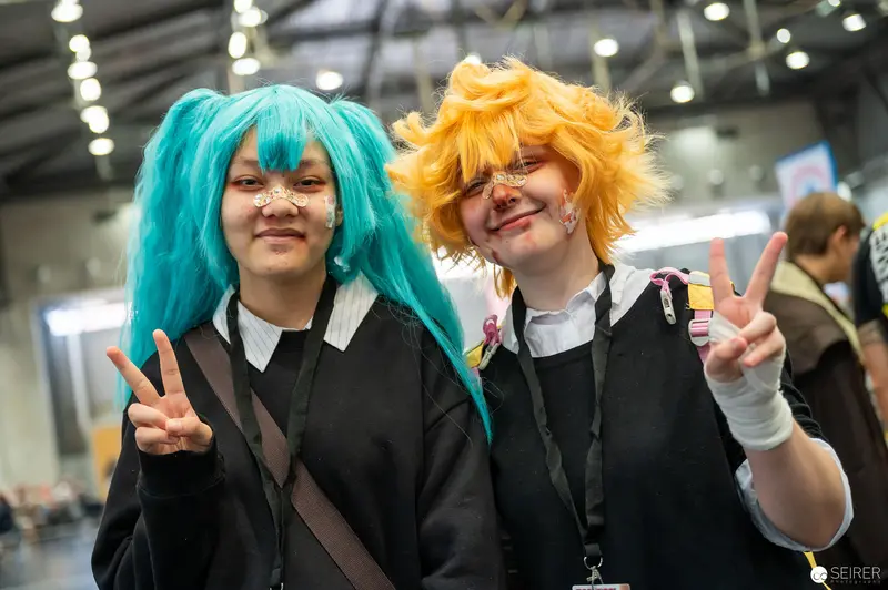 Cosplayers in Vibrant Wigs Pose at Vienna ComicCon 2022