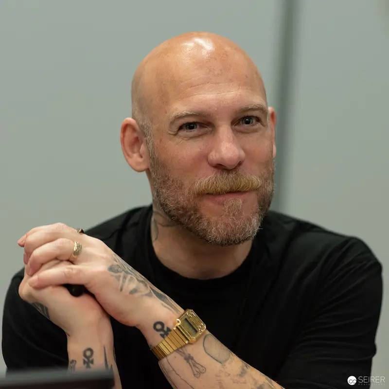 Bald Tattooed Artist in Black at Vienna ComicCon 2023