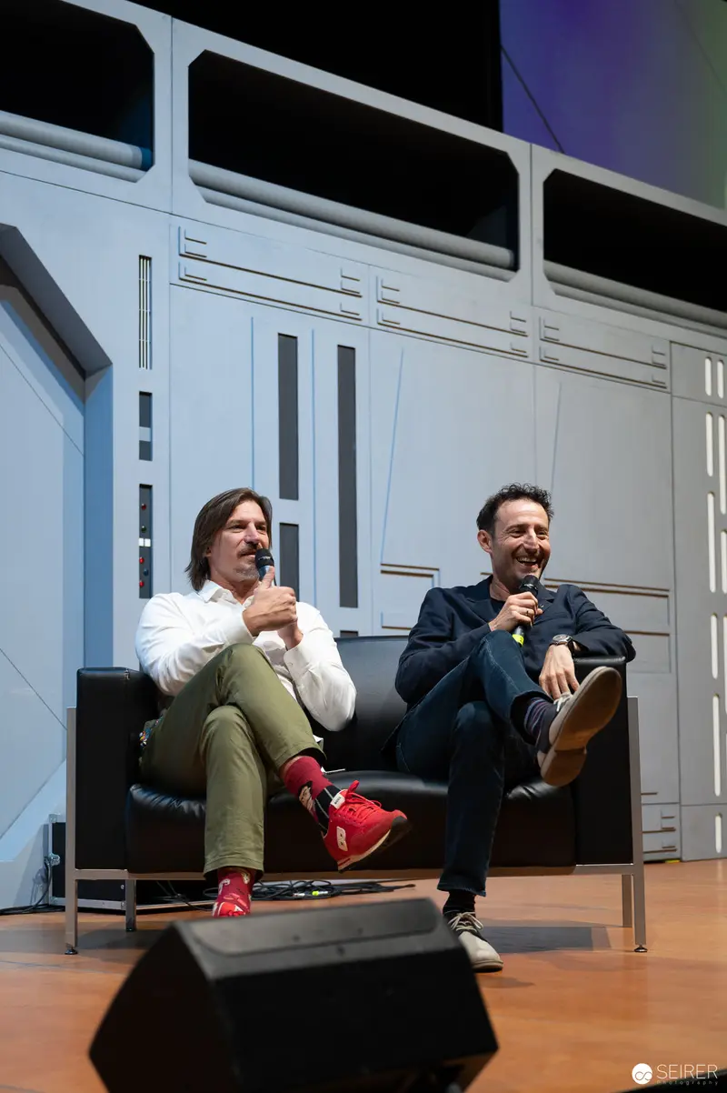 Two Speakers at Vienna ComicCon 2022 Seated on Minimalist Stage