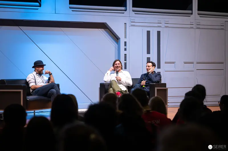 Panel Discussion at Vienna ComicCon 2022 with Three Speakers on Stage