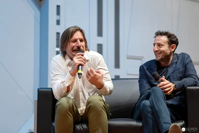 Comic Con Panelists Engaged in Animated Discussion at Vienna Event