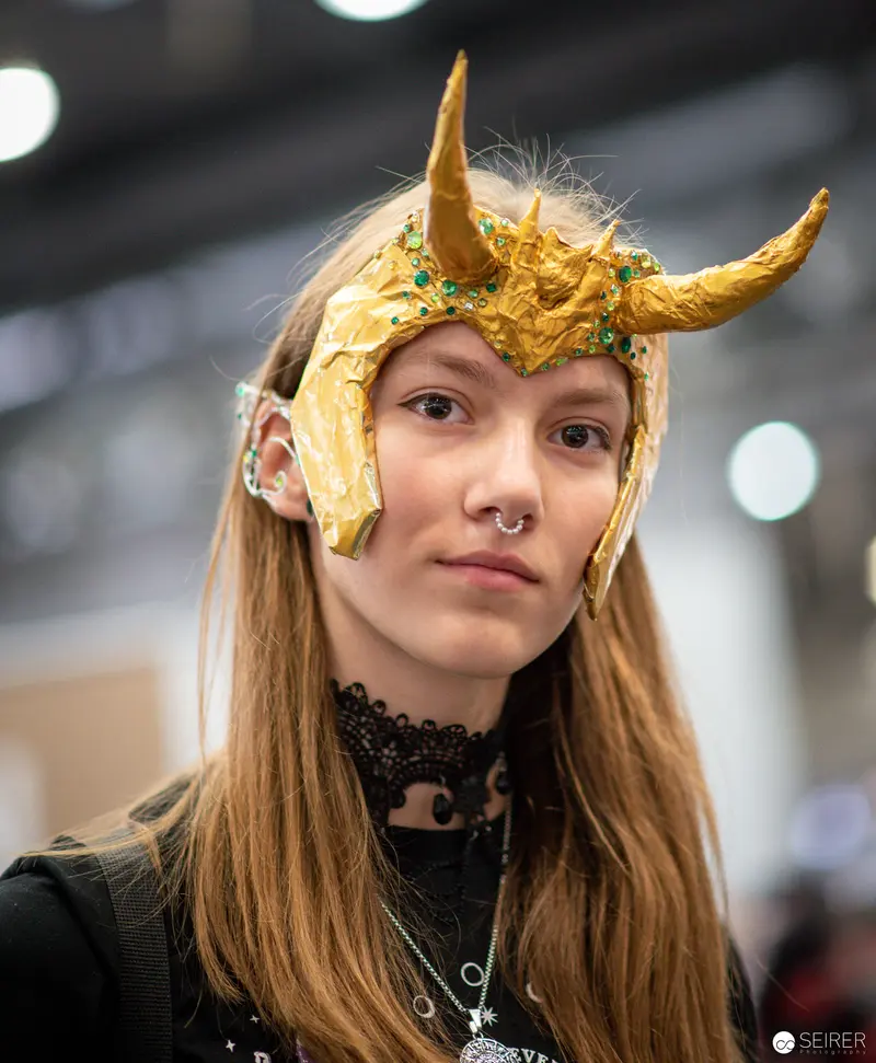 Cosplayer in Golden Horned Headdress at Vienna ComicCon 2023
