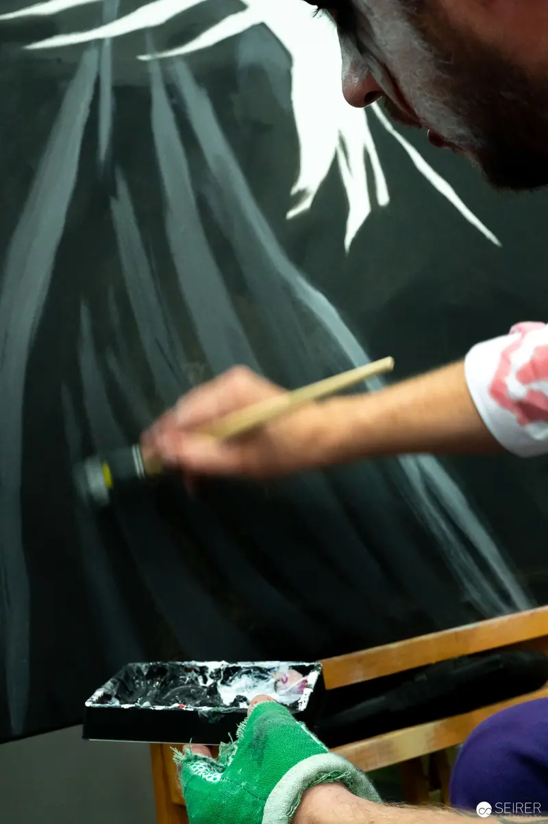 Painter Working with Palette Knife on Dark-Toned Canvas