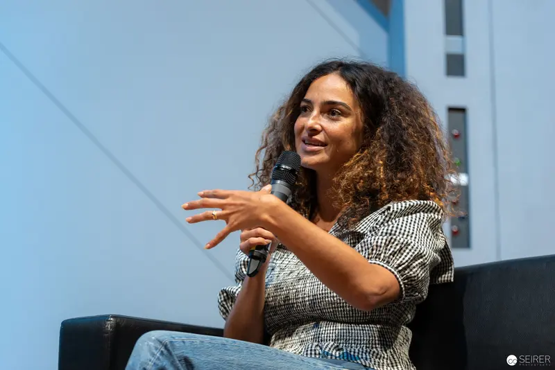 Speaker Gesturing Dynamically During Panel Discussion at Vienna ComicCon