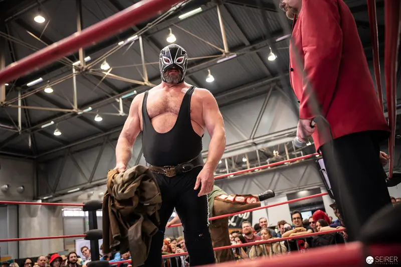 Masked Wrestler in Black Outfit Performs at Vienna ComicCon 2022