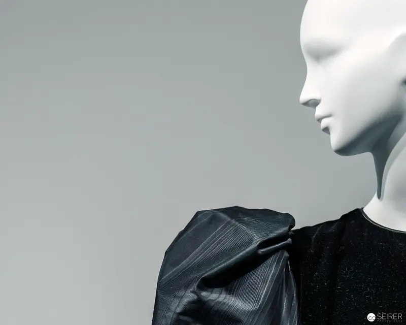 Minimalist Mannequin Profile with Sculptural Black Textile Draping