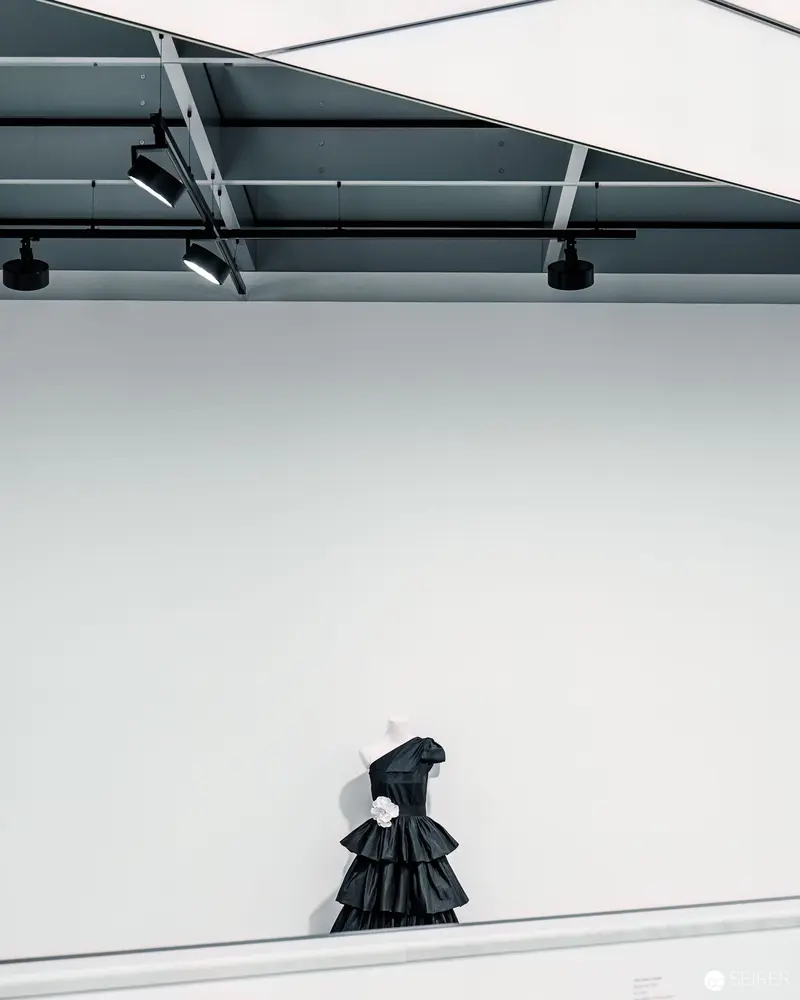 Black Ruffled Dress Isolated in Minimalist Gallery Space During Heidi Horten Exhibition