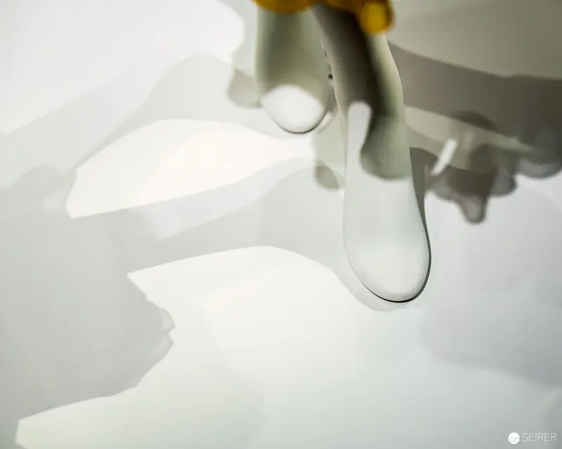 Playmobil Figure Casting Intricate Shadow on White Surface