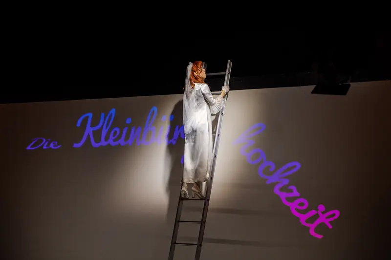 Brecht's "Small Bourgeois Wedding" - Actress on Ladder in Dramatic Staging