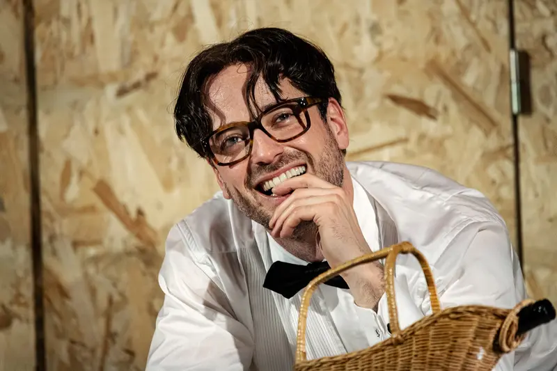 Brecht's Kleinbürgerhochzeit: Smiling Actor in White Shirt and Bowtie