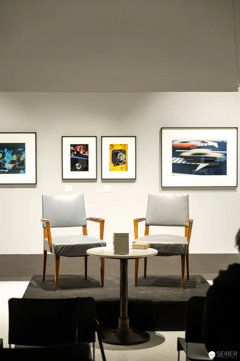 Gallery Interior with Midcentury Chairs and Framed Photographic Art