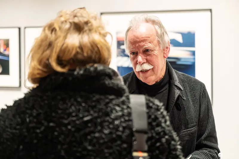 Hans-Michael Koetzle in Contemplative Discussion at Photography Exhibition