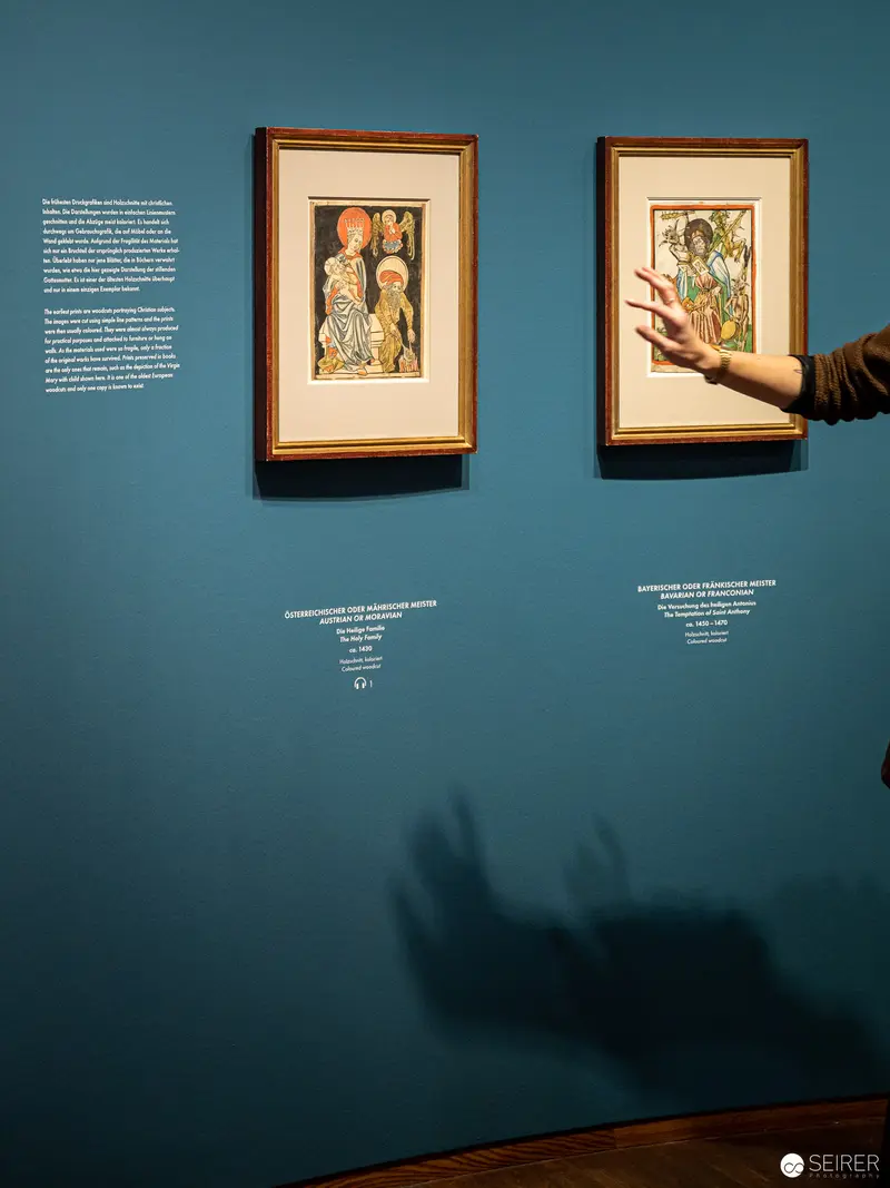 Albertina Exhibition View: Framed Artworks with Visitor's Pointing Hand