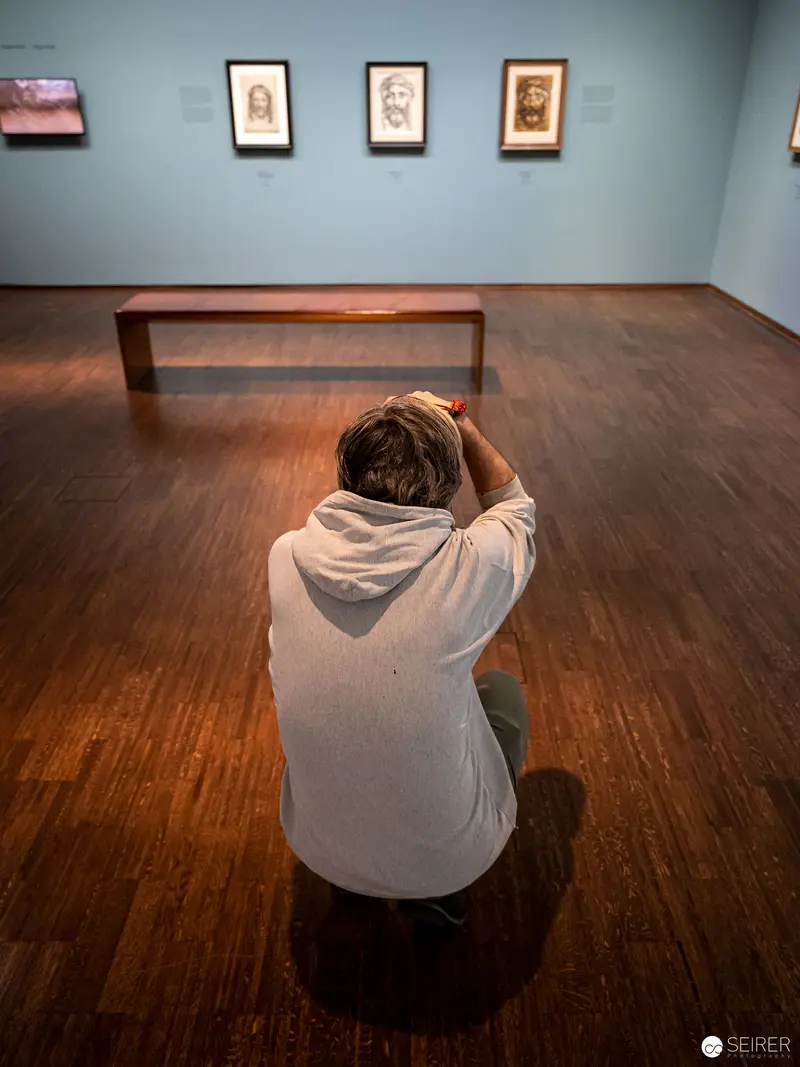 Contemplative Visitor Examining Prints at Dürer, Munch, Miro Exhibition, Albertina Vienna