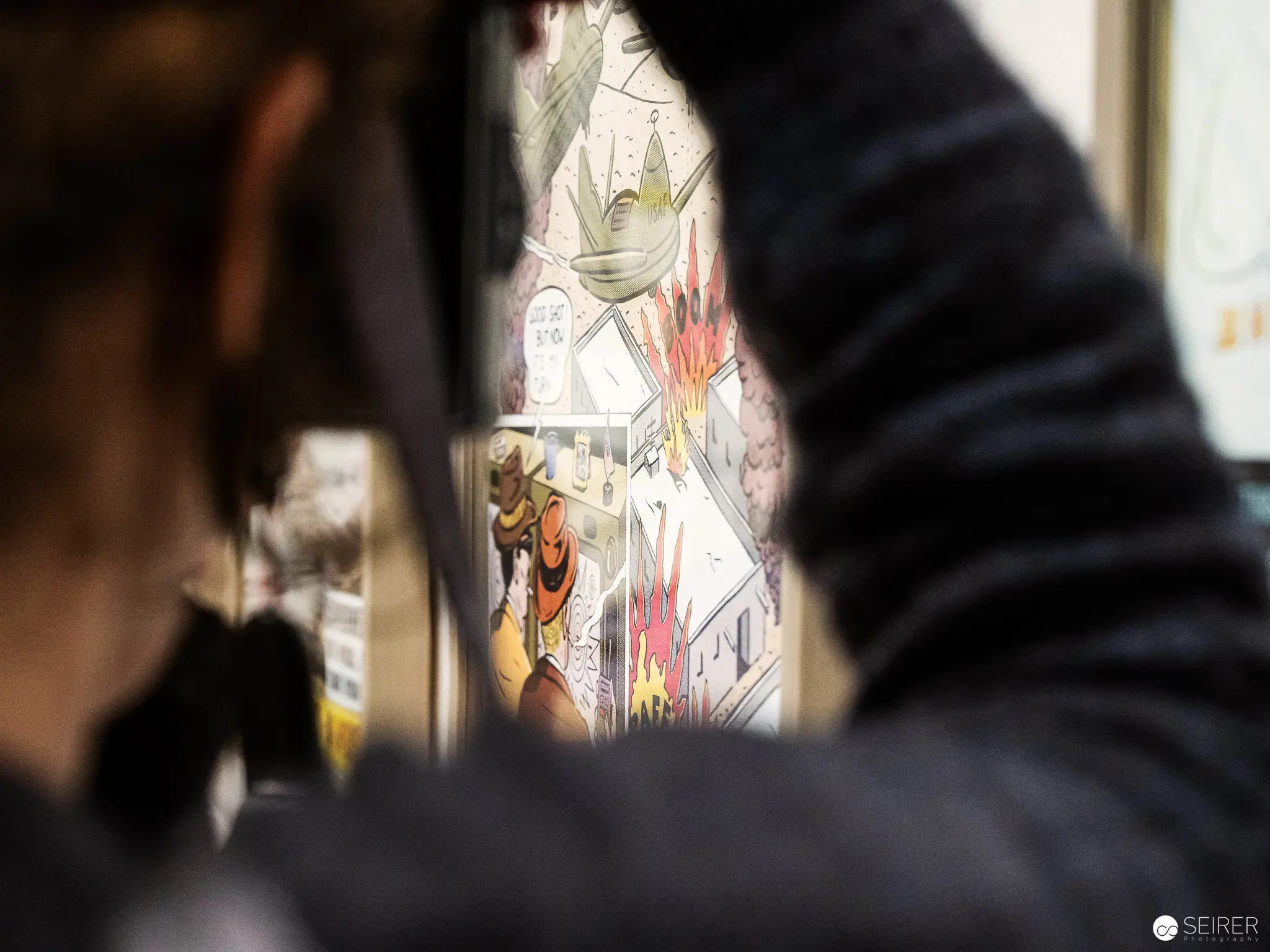 Viewer Observing Comic Book Imagery at Albertina Modern's Print Revolution Exhibition