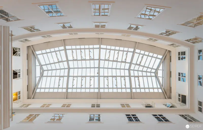 Luminous Atrium of Webster University Vienna: Architectural Symmetry and Light
