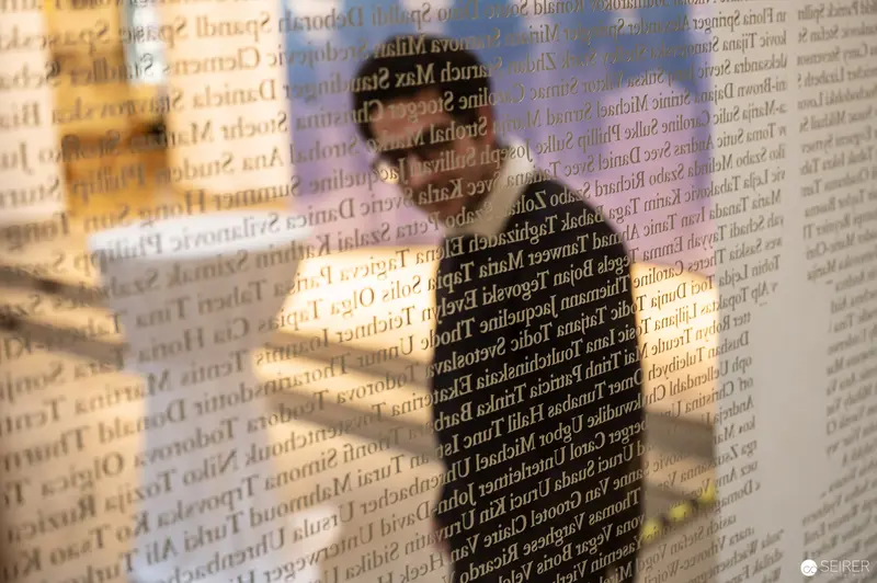 Text-Overlaid Figure at Webster University Vienna: Layered Perspectives in Architectural Space