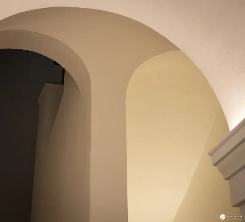 Architectural Study of Curved Archways in Neutral Tones at Webster University Vienna