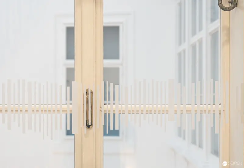 Minimalist Architectural Detail of Frosted Glass and Wooden Frame at Webster University Vienna