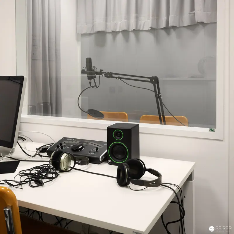 Recording Studio Setup with Headphones, Speakers, and Microphone Arm