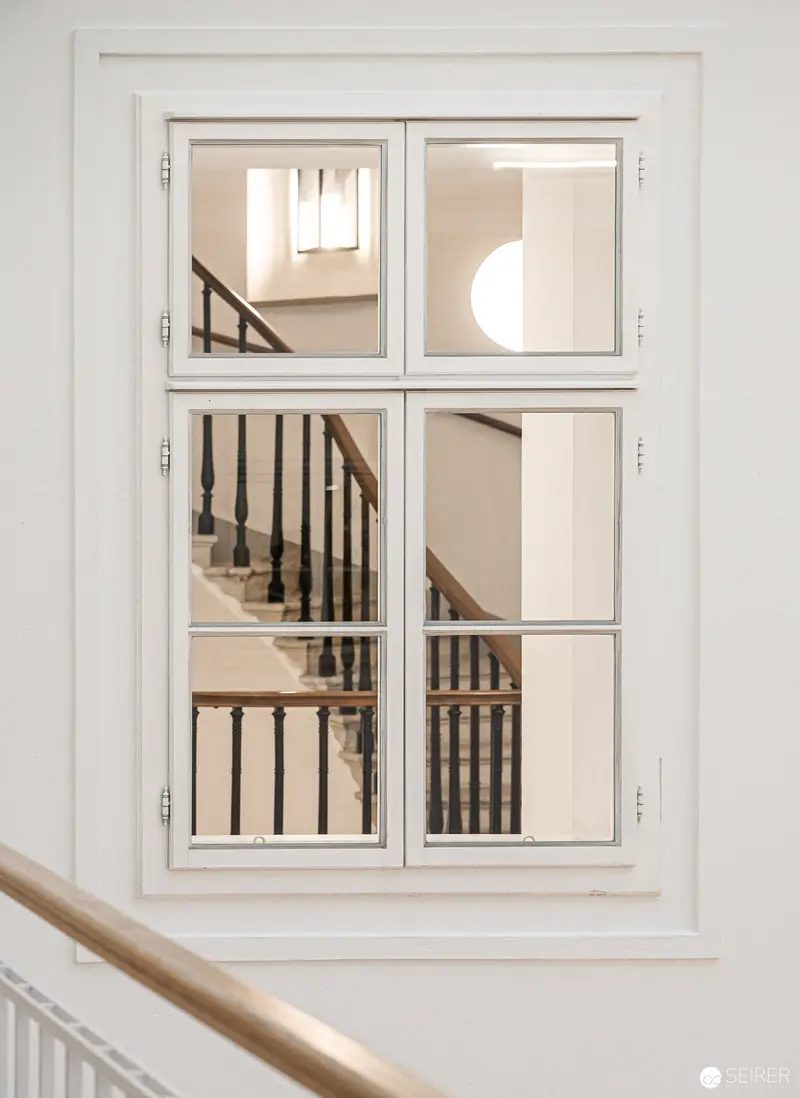 Interior Architectural Study of Minimalist White Stairwell Through Divided Window Panes