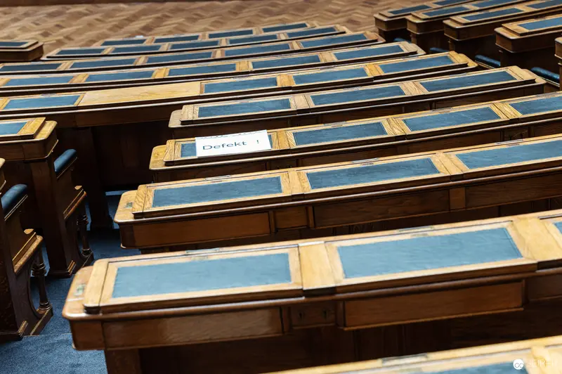 Detailed Wooden Lecture Hall Seats with Blue Accents in Historic Venue