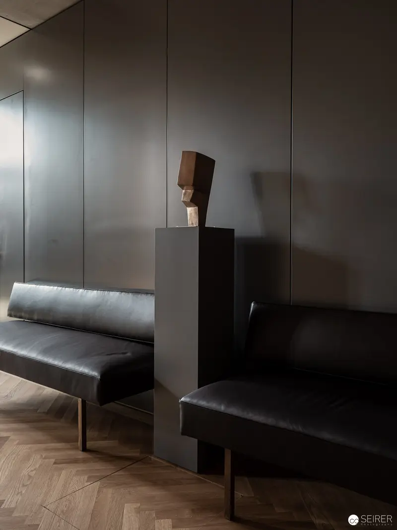 Minimalist Interior with Abstract Sculptural Head and Leather Seating