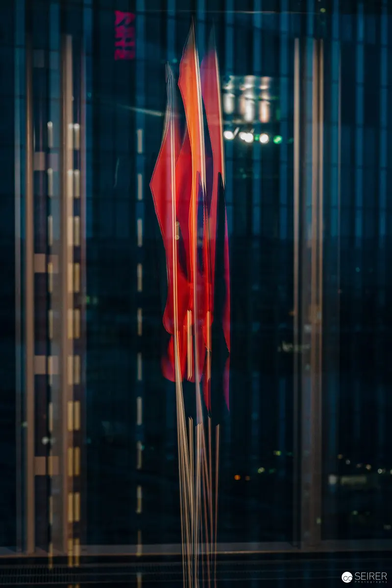 Luminous Red Incense Sticks Illuminated Through Gallery Window
