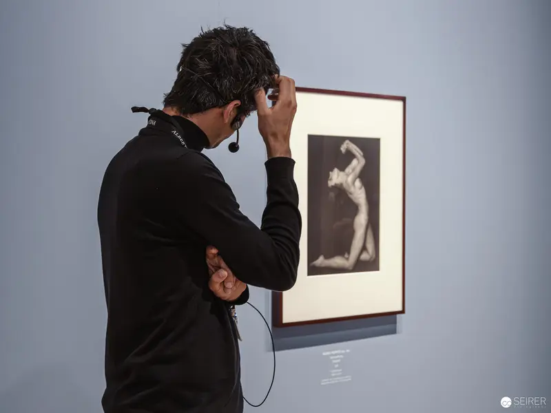 Visitor Examining Black-and-White Nude Photograph at Piktorialismus Exhibition, Albertina Modern
