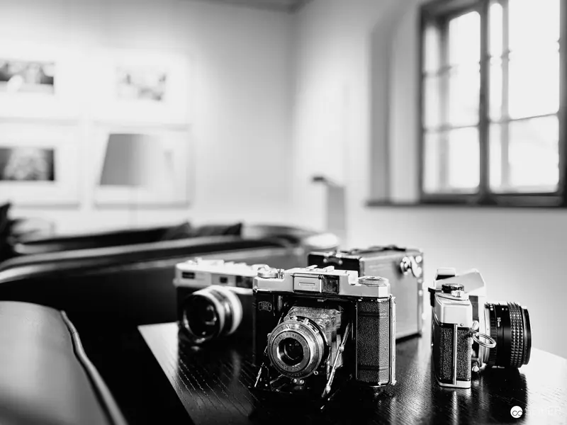 Vintage Cameras on Wooden Surface in Black and White Study