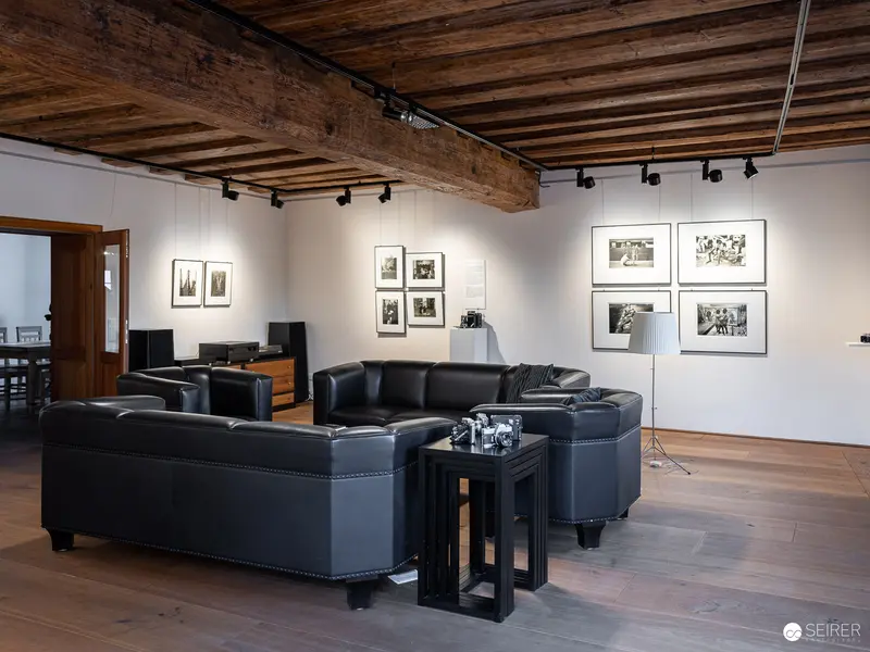 Exhibition View of "17 Sisters" Photographic Gallery in Rustic Wooden-Beamed Space