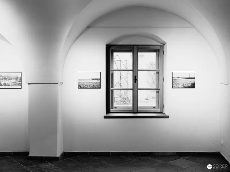 Arched Gallery Interior with Landscape Photographs at Traismaur Fine Art Exhibition
