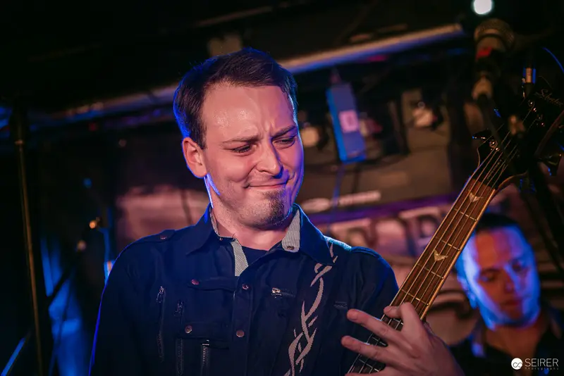 Bassist Performing with Intense Expression at Replugged Vienna Concert
