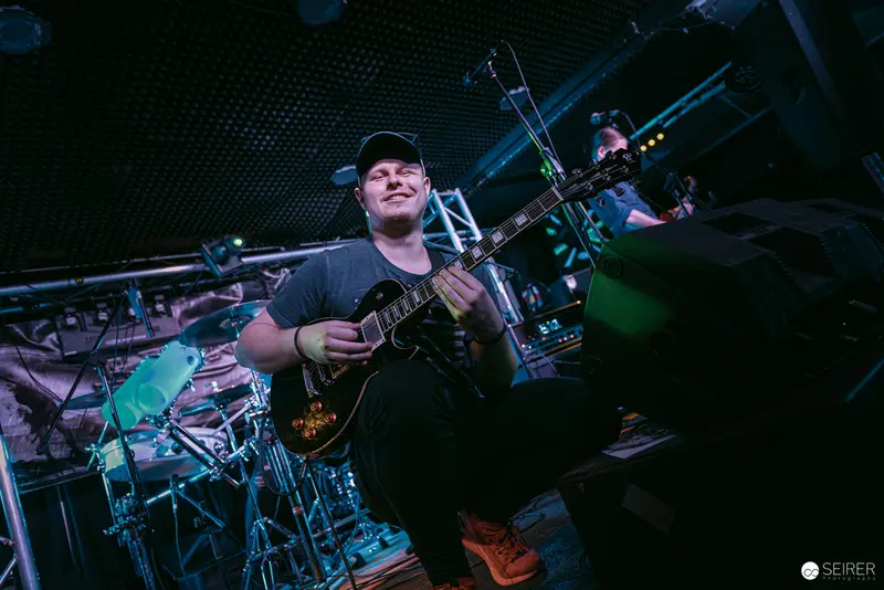 Guitarist Performing with Intense Expression at Replugged Vienna Concert