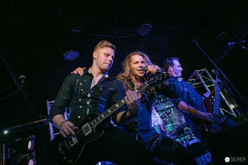 Erin at Replugged: Rock Band Performance in Dynamic Stage Lighting