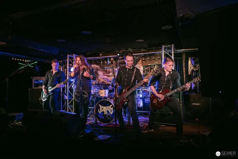 Erin at Replugged: Rock Band Performing Under Blue Stage Lighting in Vienna