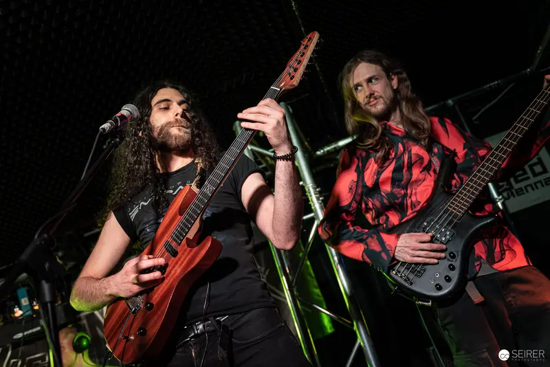 Extreme Mind Guitarists Performing Dynamic Stage Setup at Replugged