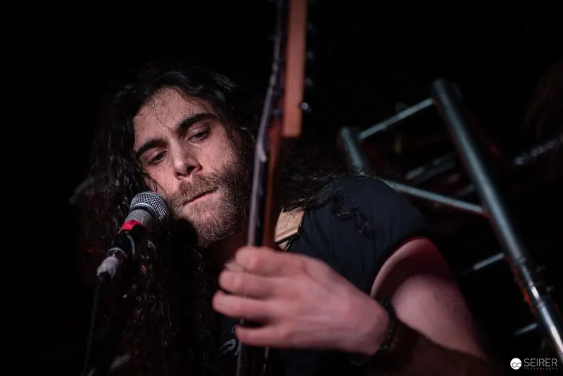 Extreme Mind Performer Singing and Playing Guitar at Replugged Concert