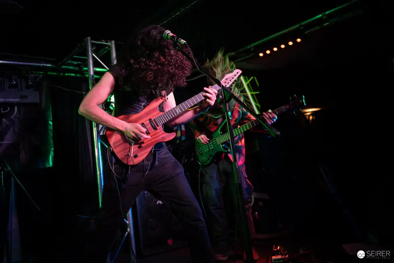 Extreme Mind Guitarists Performing Intense Rock Set at Replugged