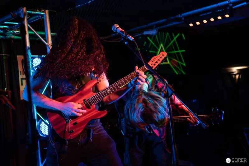 Extreme Mind's Intense Performance at Replugged - Dynamic Metal Guitar Interaction