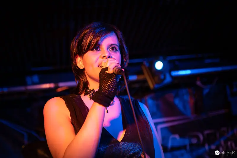 Extreme Mind Vocalist Performing at Replugged with Dramatic Blue Stage Lighting