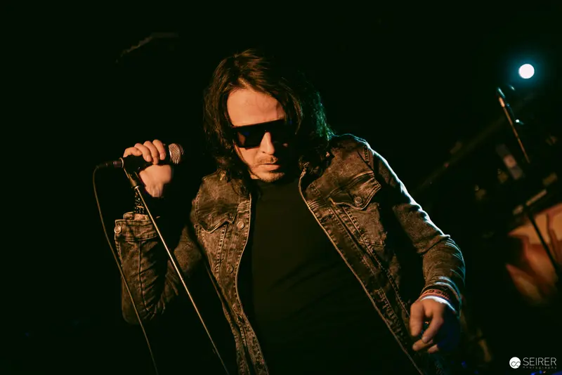 Lead Singer of Jokers IV Performing Intense Set at Replugged, Vienna